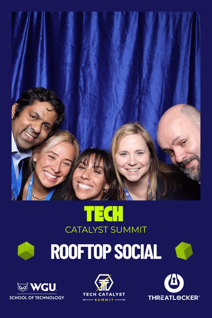 Guests at a Tech Catalyst Summit rooftop social photo booth